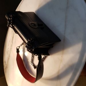 Louboutin cross shoulder purse.